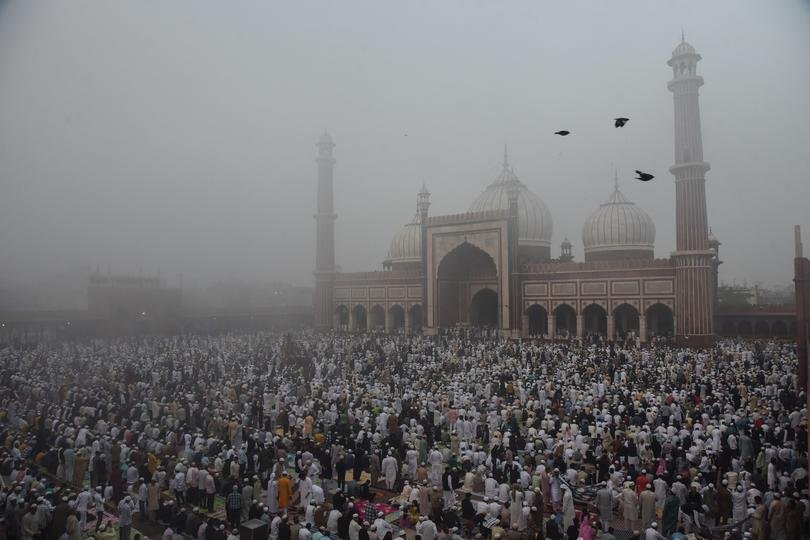 Muslim devotees offer prayers amid fog at the Jama Masjid on an early morning on the occasion of Id-ul-Fitr, in New Delhi on March 21, 2026.
